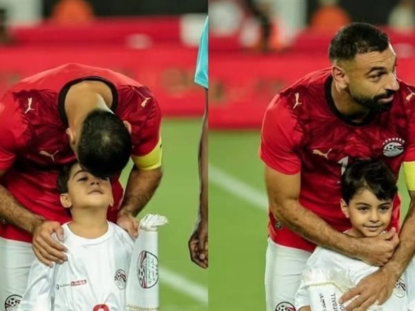 صورة : محمد صلاح مع ابن شقيقه أثناء عزف النشيد الوطني